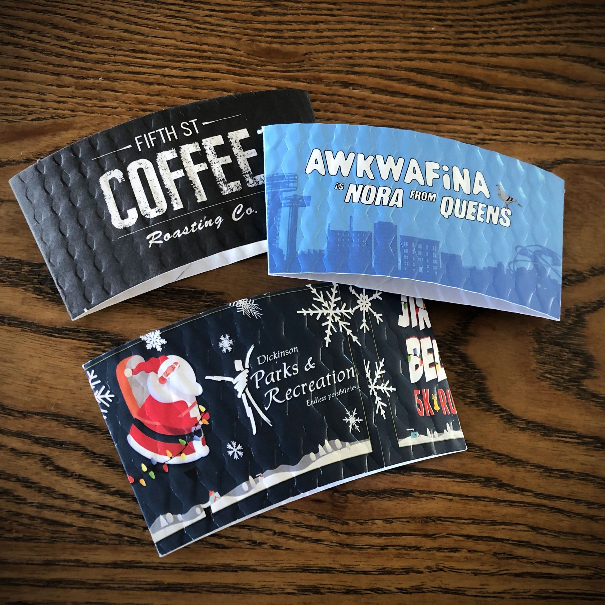 Assortment of custom printed coffee cup sleeves printed in full color and are placed on a table top