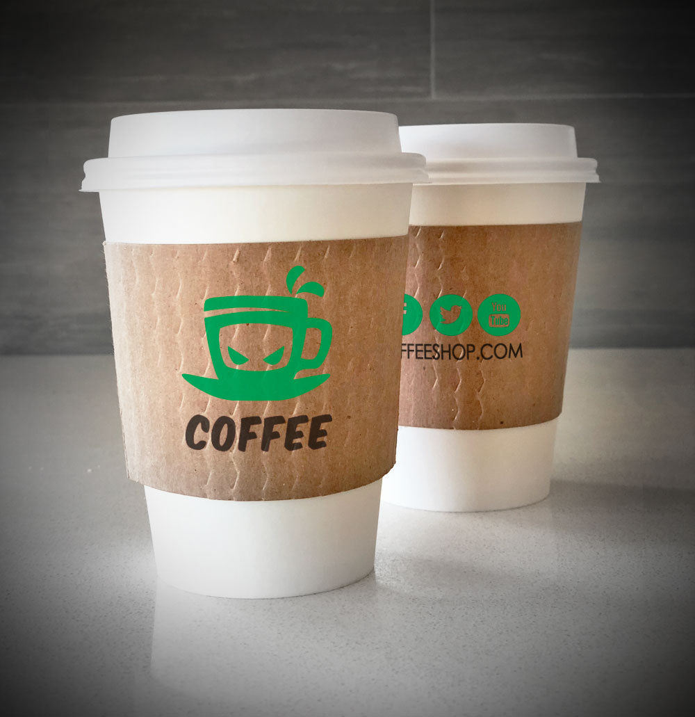 Kraft custom printed cup sleeves printed with 2 colors on both sides placed on 2 white paper cups and are placed on countertop