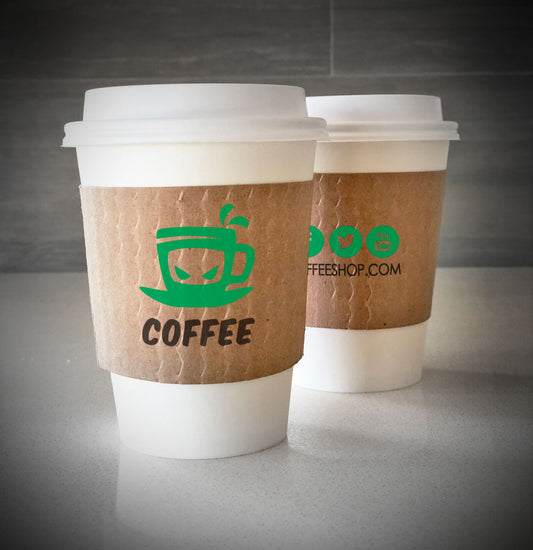 Kraft custom printed cup sleeves printed with 2 colors on both sides placed on 2 white paper cups and are placed on countertop