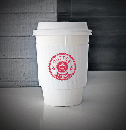 White printed coffee cup sleeves printed on front with one color is wrapped on white paper cup sitting on a counter