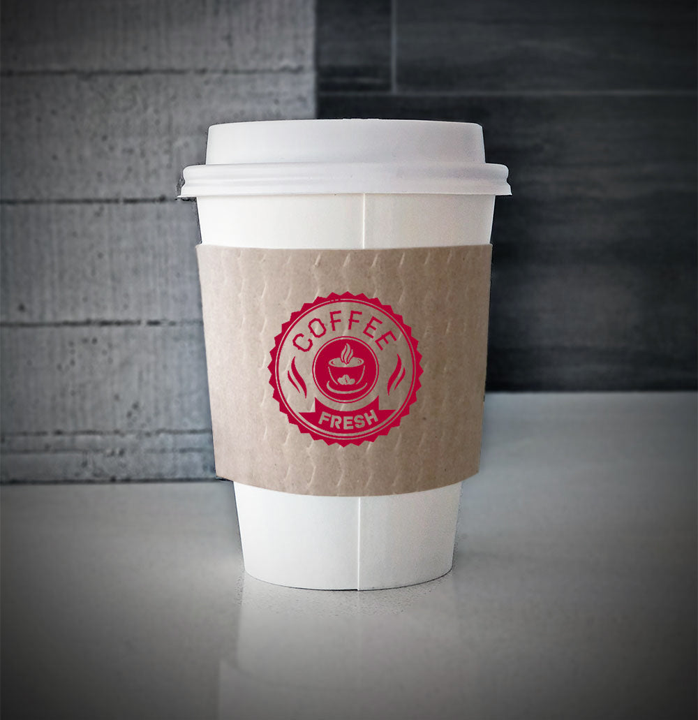 Kraft Printed coffee cup sleeves printed on front with one color wrapped on a white paper cup sitting on a countertop