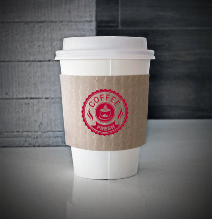 Kraft Printed coffee cup sleeves printed on front with one color wrapped on a white paper cup sitting on a countertop