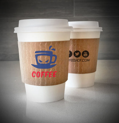 Kraft cup custom cup sleeves printed with two colors on front and one color on back placed on 2 white paper cups placed on a table top
