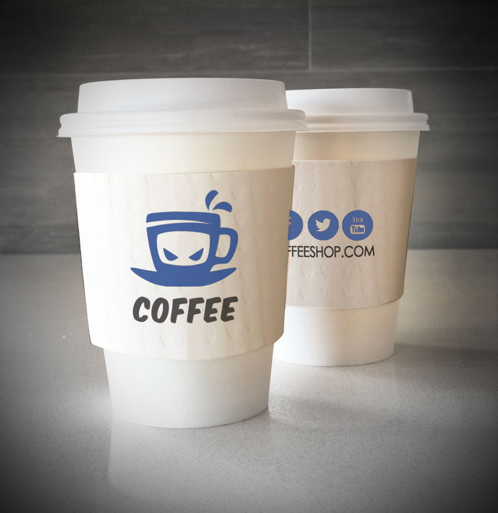White cup custom printed cup sleeves printed in 2 colors on both sides placed on 2 white paper cups and are placed on countertop
