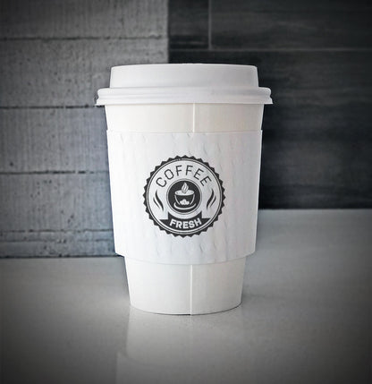 Printed coffee cup sleeves printed on white sleeves with one color on front placed on a white paper cup sitting on a countertop