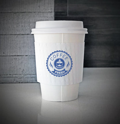 White Printed coffee cup sleeves printed on front with one color and is wrapped around a white paper cup sitting on a countertop